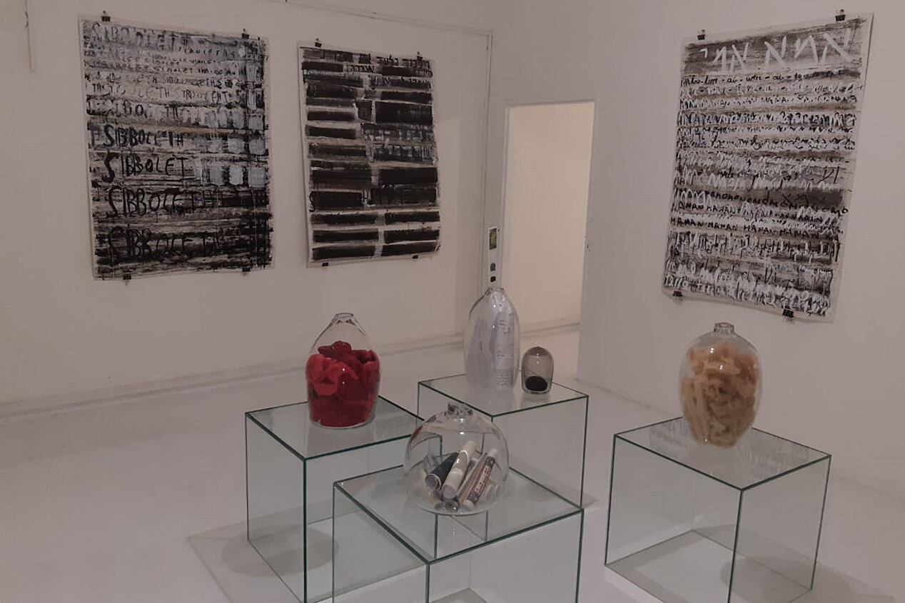 Hand-blown glass capsules containing mementos related to displacement and associated trauma