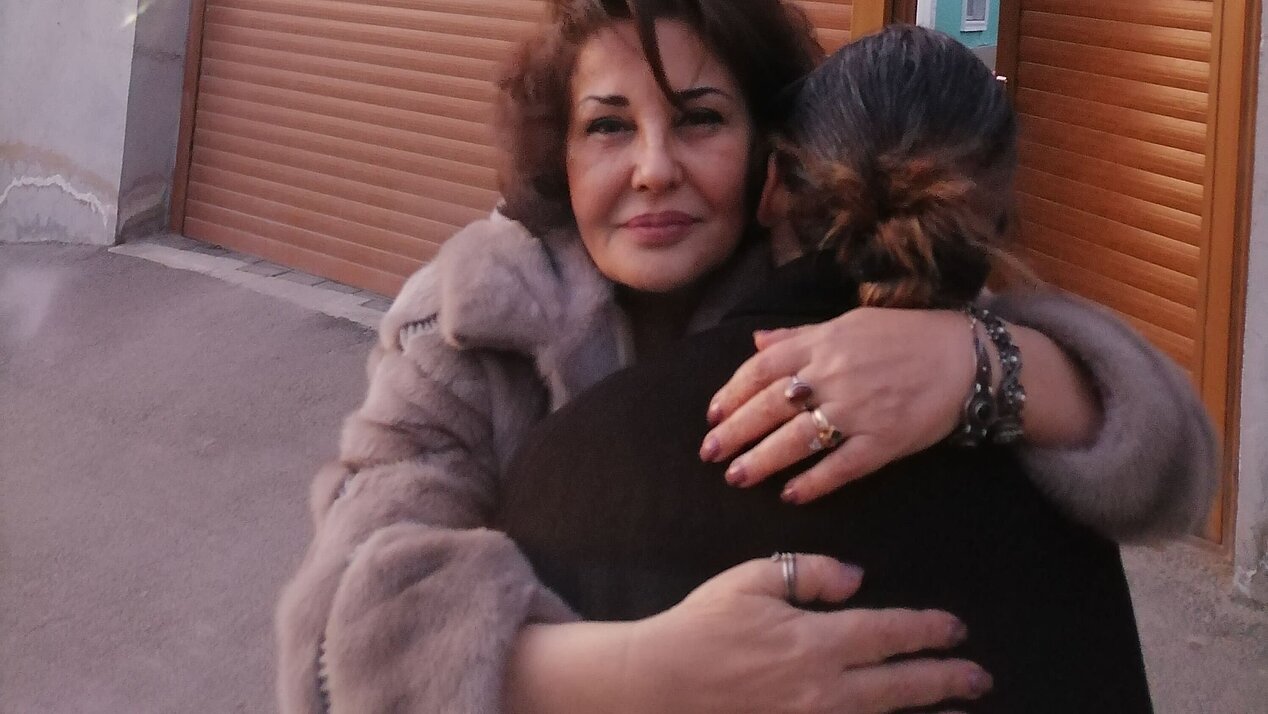 Founder Mehriban Zeynalova hugs a woman in front of her shelter. Photograph: Ismayil Fataliyev