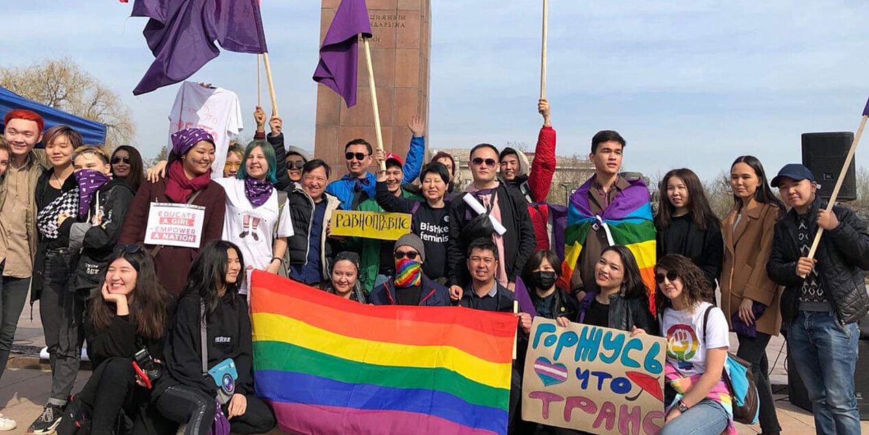 Feminists and LGBT+ activists celebrating the International Women's Day in Bishkek with purple and rainbow flags 