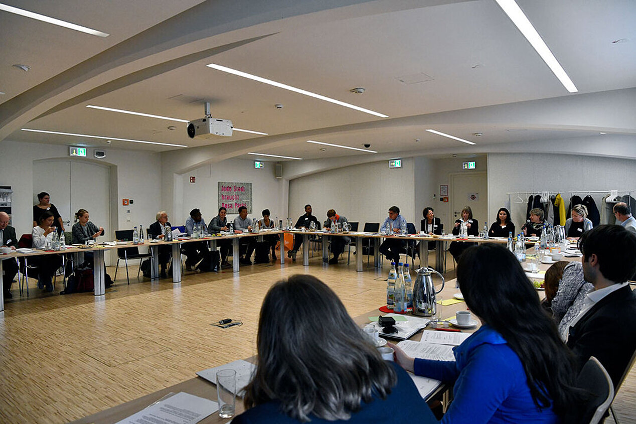 Participants in the WIKA workshop in 2019 sit in a large circle at tables