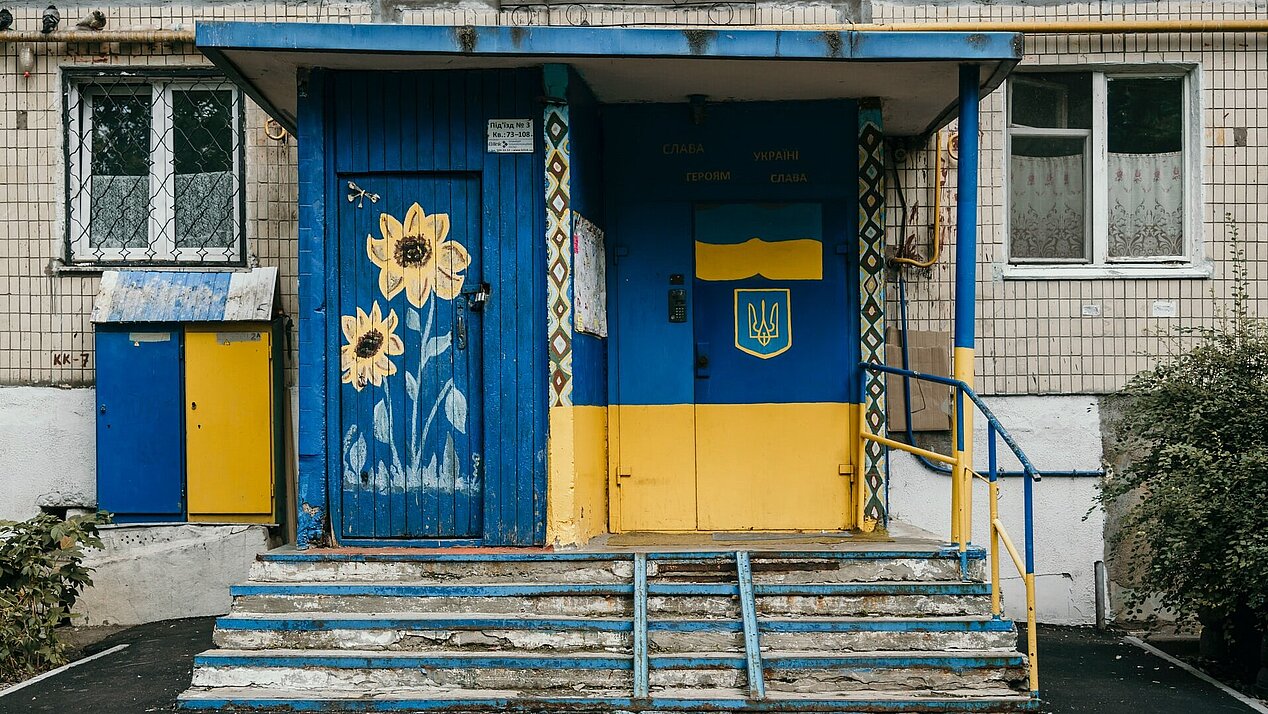 House in Kiyv with entrance in the colours of the Ukrainian flag. Photograph: Marjan Blan via unsplash